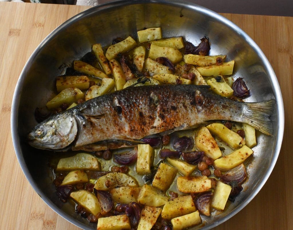 Baked Topani fish with grapes and potatoes