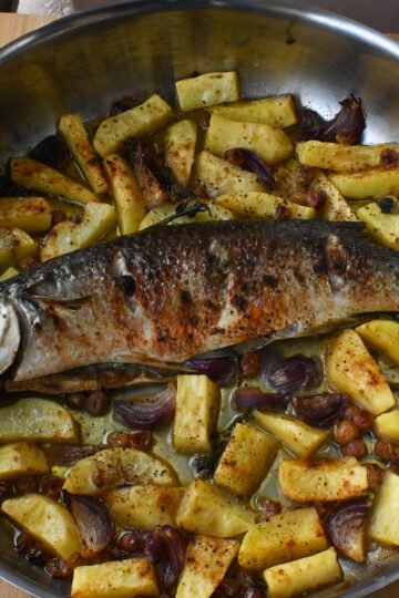 Baked Topani fish with grapes and potatoes