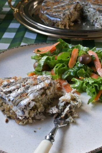 Traditional baked rice with anchovies and pine nuts